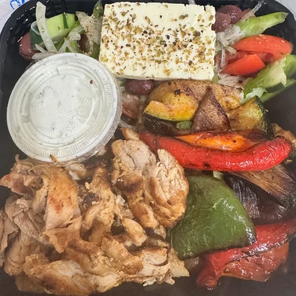 Greek Guys Souvlaki plate with chicken, grilled vegetables, feta, salad, and tzatziki.